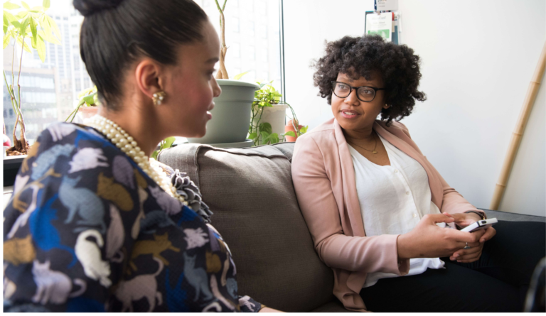 photo of who women sitting next to each other as a visual representation of one to one coaching sessions on the journey to self-love