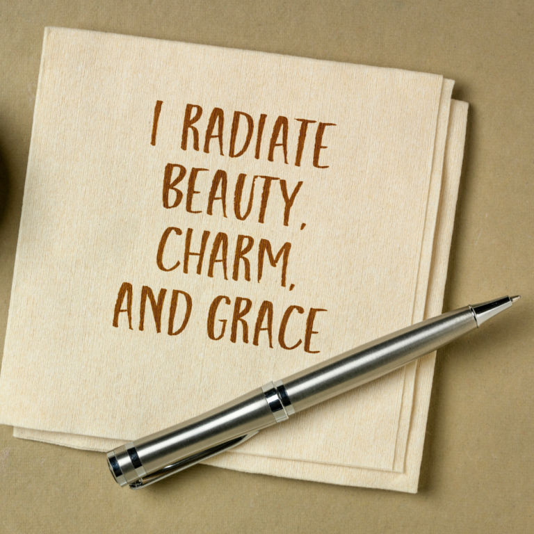 napkin with a pen next to it and the affirmation "I radiate beauty, charm and grace" as a visual representation of affirmations.